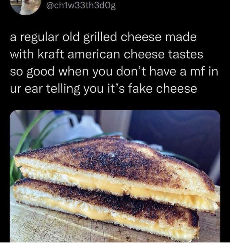 a close up of a grilled cheese sandwich on a cutting board