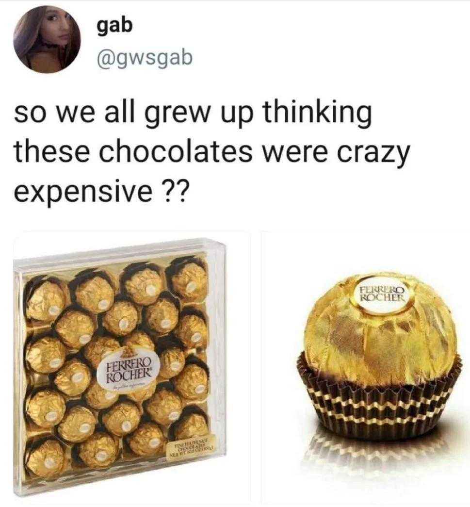 a close up of a box of chocolates next to a chocolate covered in gold